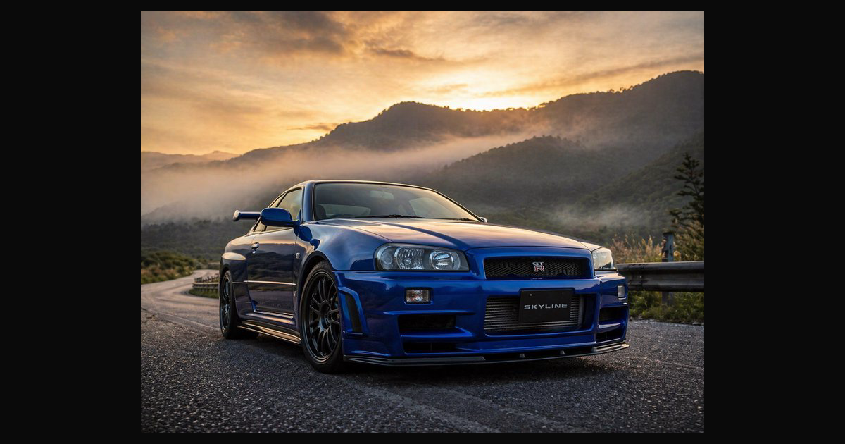 A striking blue Nissan Skyline GT-R R34 sits on a | gonzafa on ...